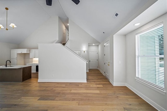 living room featuring a wealth of natural light, light hardwood / wood-style floors, and sink