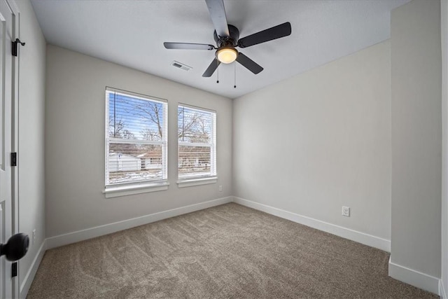 spare room featuring carpet and ceiling fan