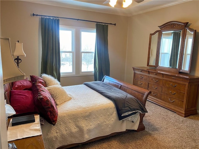 carpeted bedroom featuring ceiling fan and ornamental molding