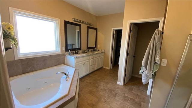 bathroom featuring vanity and a relaxing tiled tub