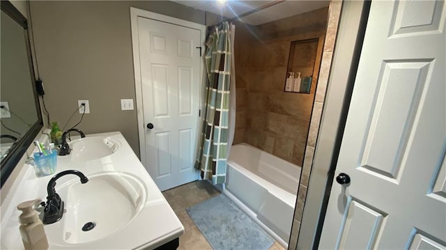 bathroom featuring tile patterned flooring, vanity, and shower / bath combo with shower curtain