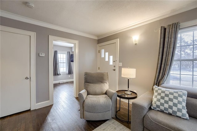 living area with a wealth of natural light, dark hardwood / wood-style flooring, and ornamental molding