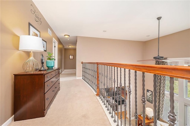 hallway featuring light colored carpet