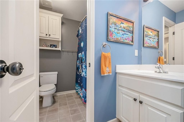 bathroom with vanity, toilet, and tile patterned flooring