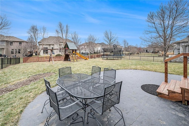 view of patio featuring a trampoline and a playground