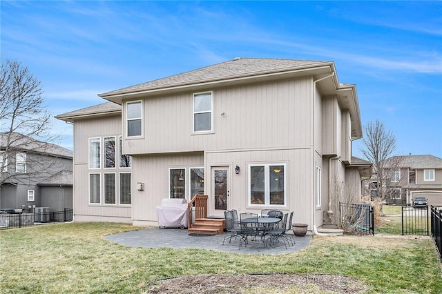 rear view of property featuring a patio and a yard