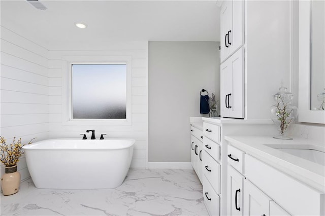 bathroom with vanity and a tub to relax in