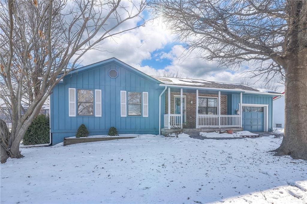 view of front of home featuring a garage and a porch