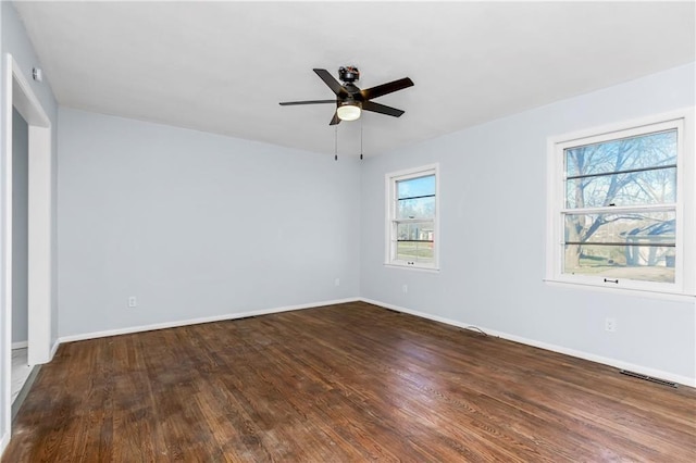 unfurnished room with ceiling fan and dark hardwood / wood-style flooring