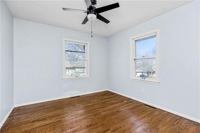 empty room featuring ceiling fan and hardwood / wood-style floors