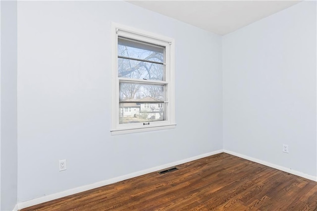 spare room with wood-type flooring