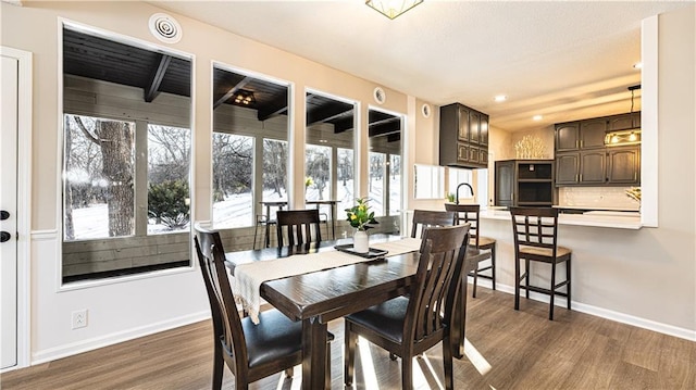 dining area with dark hardwood / wood-style flooring