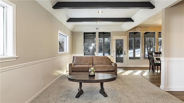 living room featuring a wealth of natural light and beamed ceiling