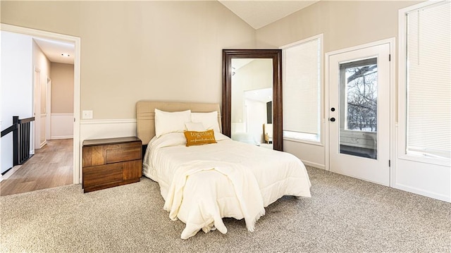 bedroom with carpet floors, access to exterior, and vaulted ceiling