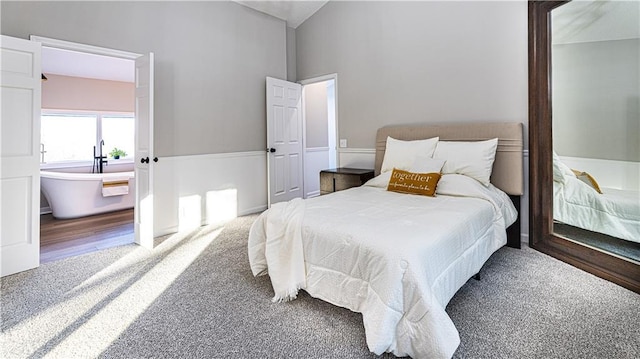 carpeted bedroom featuring vaulted ceiling