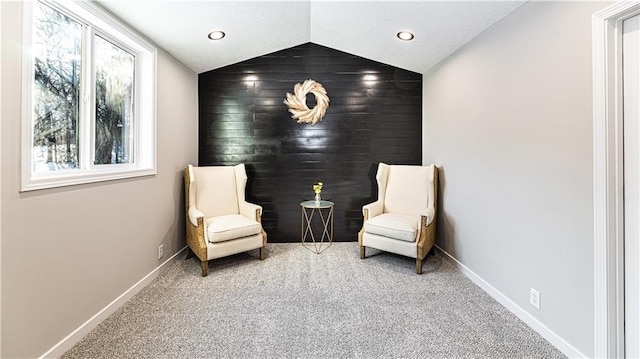 living area with vaulted ceiling and carpet flooring