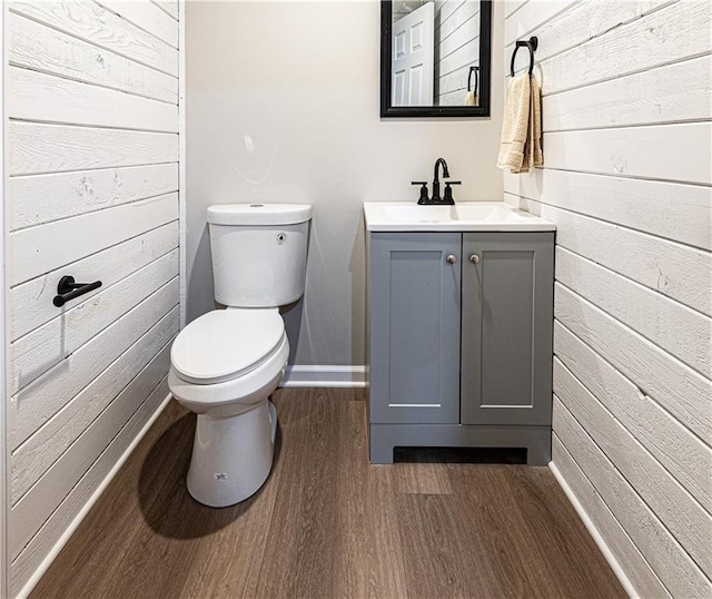 bathroom with hardwood / wood-style floors, toilet, and vanity