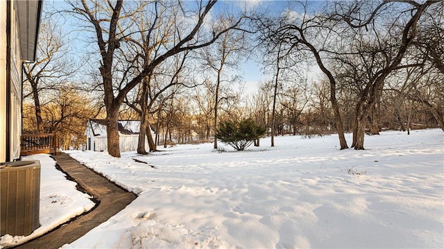 snowy yard with central AC