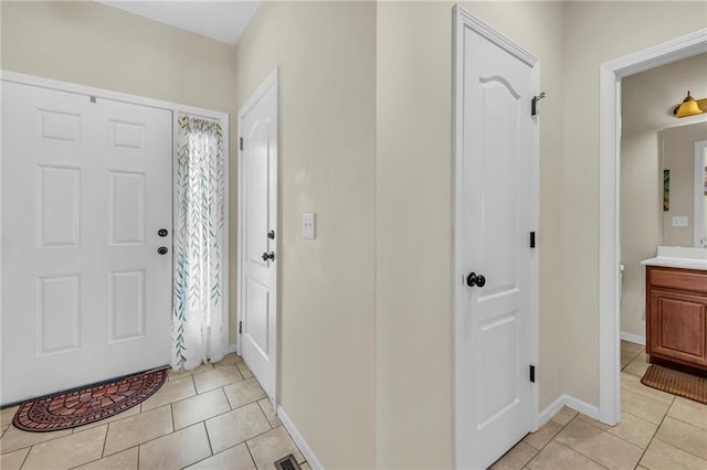 foyer featuring light tile patterned floors