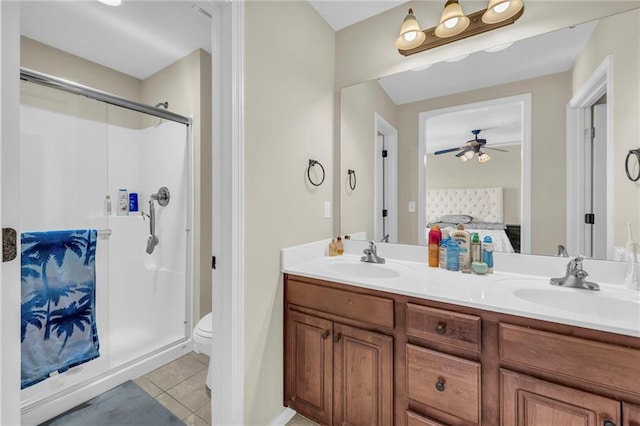 bathroom with vanity, ceiling fan, walk in shower, toilet, and tile patterned floors