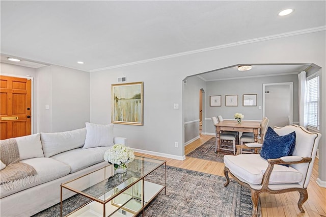 living room featuring crown molding and hardwood / wood-style floors