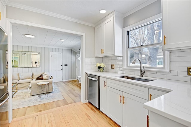 kitchen featuring dishwasher, sink, and white cabinets