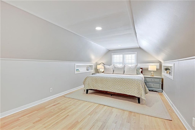 bedroom featuring lofted ceiling and light wood-type flooring