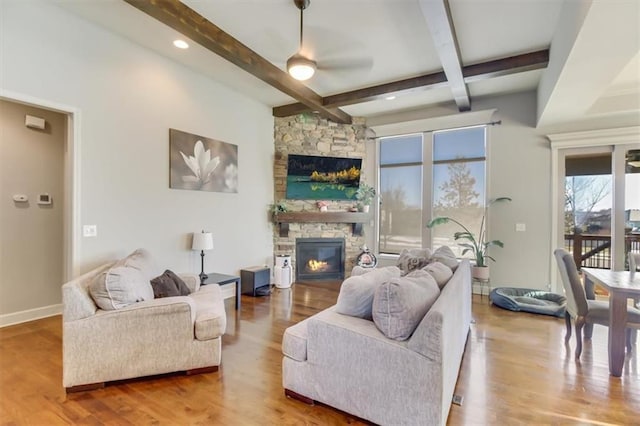 living room with coffered ceiling, beam ceiling, a fireplace, and light wood-type flooring