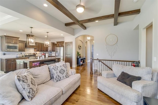 living room with beam ceiling and light hardwood / wood-style floors