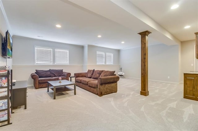 living room with ornate columns, ornamental molding, and light colored carpet