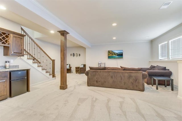 carpeted living room featuring crown molding and indoor bar