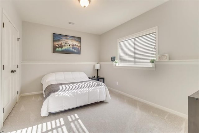 carpeted bedroom with a closet