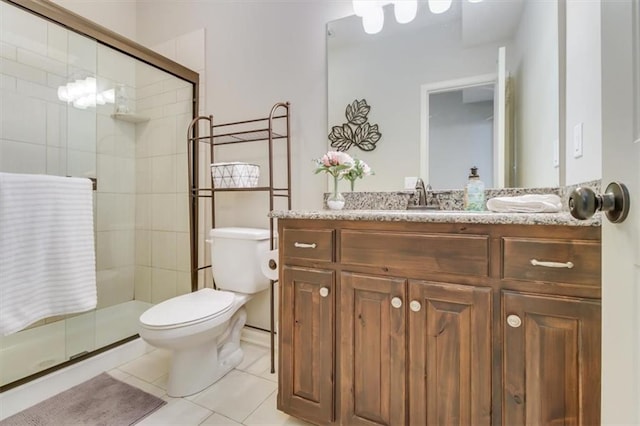 bathroom featuring tile patterned flooring, vanity, toilet, and an enclosed shower