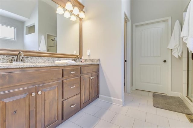 bathroom with tile patterned floors, vanity, and an enclosed shower