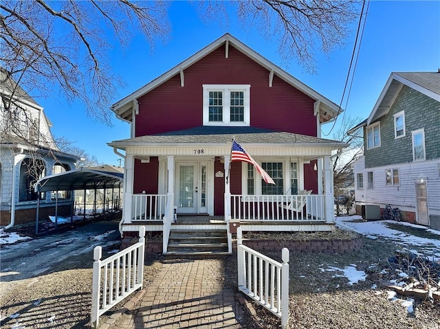 view of front of property with covered porch and a carport