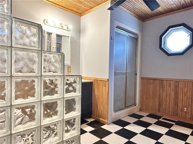 bathroom featuring wood walls, wooden ceiling, and crown molding