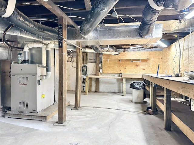 basement with heating unit and a workshop area