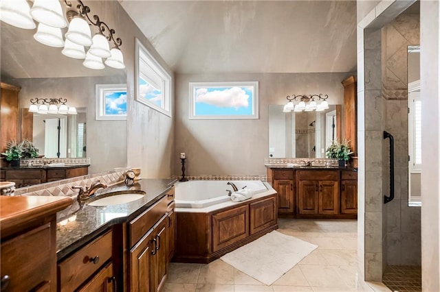 bathroom featuring independent shower and bath, vanity, and lofted ceiling