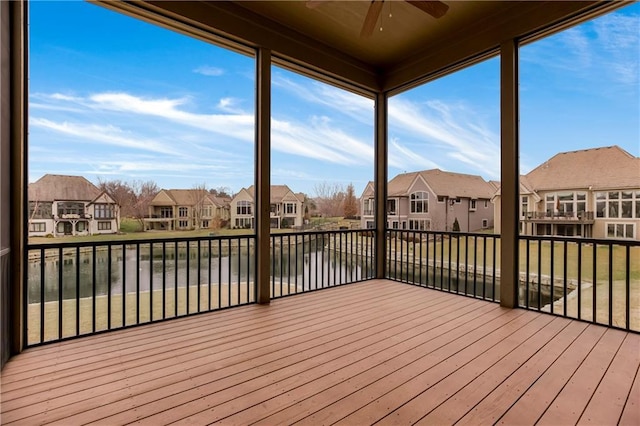 unfurnished sunroom with ceiling fan