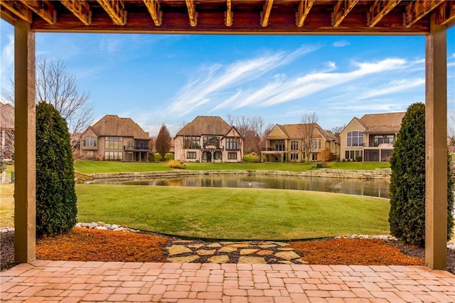 view of yard with a water view and a patio area