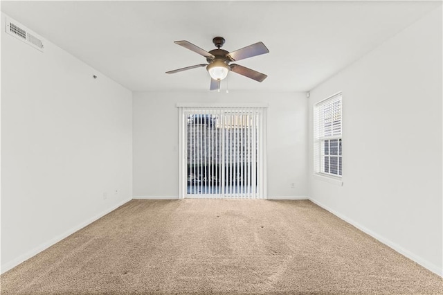 unfurnished room with ceiling fan and carpet