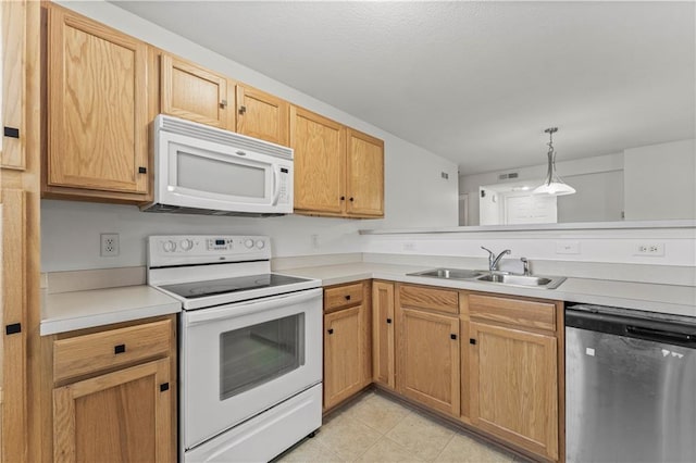 kitchen featuring sink, light brown cabinets, light tile patterned floors, pendant lighting, and white appliances