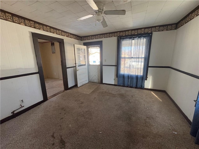 carpeted spare room with ceiling fan