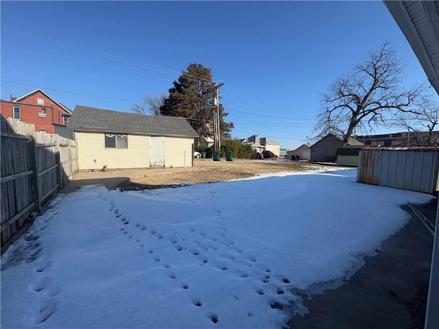 yard layered in snow with an outdoor structure