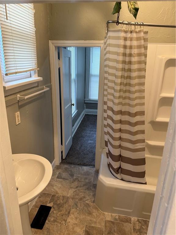 2901 Messanie St, Saint Joseph, MO 64501 - bathroom with shower / tub combo, stone finish floors, and a sink
