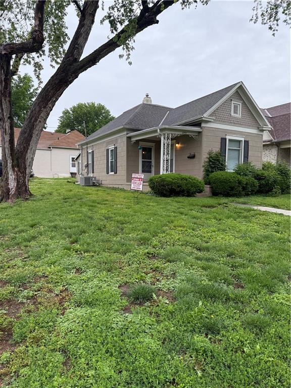 2901 Messanie St, Saint Joseph, MO 64501 - view of front of house featuring a front yard, a chimney, and central AC unit