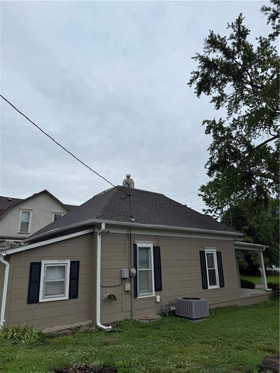 2901 Messanie St, Saint Joseph, MO 64501 - back of property featuring a yard, central air condition unit, and roof with shingles