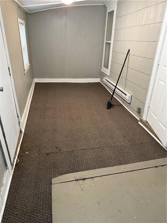 2901 Messanie St, Saint Joseph, MO 64501 - unfurnished room with carpet flooring, wood walls, and baseboards