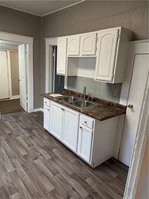 2901 Messanie St, Saint Joseph, MO 64501 - kitchen featuring a sink, dark wood-type flooring, white cabinetry, and dark countertops