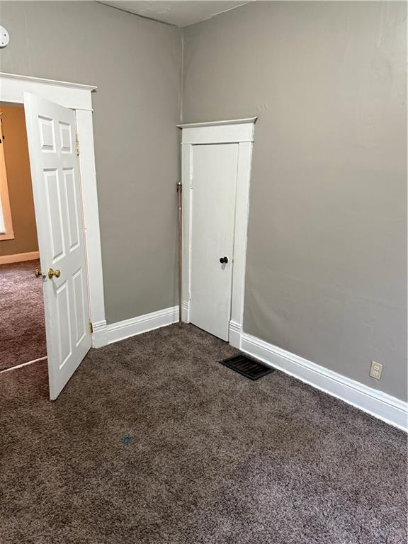 2901 Messanie St, Saint Joseph, MO 64501 - unfurnished room featuring dark carpet and baseboards